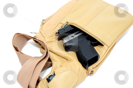 To use this stock image in your creative project, please select the size you need over to the right and click the "Add to Cart" button.
Your downloaded image will come with the Cutcaster watermark removed so don’t worry about the watermark you see on this page. Purse And Handgun stock photo, A light brown womens purse with a .45 caliber pistol, the magazine removed showing the hollow point cartridge in detail with a cell phone in the shoulder strap pouch on a light colored background by Lynn Bendickson
