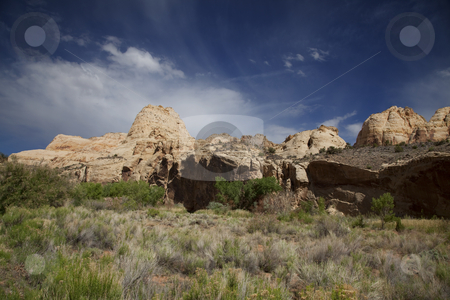 To use this stock image in your creative project, please select the size you need over to the right and click the "Add to Cart" button.
Your downloaded image will come with the Cutcaster watermark removed so don’t worry about the watermark you see on this page. Capitol Reef National Park stock photo, View of the red rock formations in Capitol Reef National Park with blue sky by Mark Smith