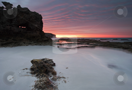 To use this stock image in your creative project, please select the size you need over to the right and click the "Add to Cart" button.
Your downloaded image will come with the Cutcaster watermark removed so don’t worry about the watermark you see on this page. Window on Dawn stock photo, A window on a glorious sunrise in a large limestone boulder on the beach at Pennington Bay South Australia by Mike Dawson