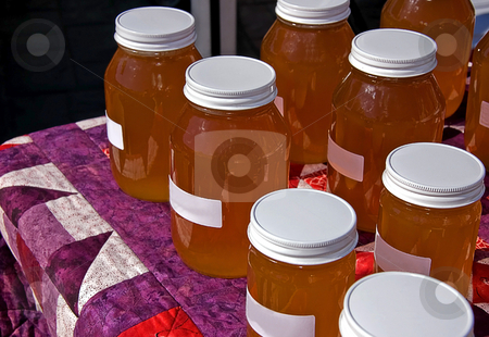 To use this stock image in your creative project, please select the size you need over to the right and click the "Add to Cart" button.
Your downloaded image will come with the Cutcaster watermark removed so don’t worry about the watermark you see on this page. Many Jars of Honey on Quilt stock photo, Table of many jars of fresh honey displayed on a homemade quilt. by Valerie Garner
