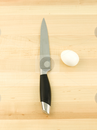 To use this stock image in your creative project, please select the size you need over to the right and click the "Add to Cart" button.
Your downloaded image will come with the Cutcaster watermark removed so don’t worry about the watermark you see on this page. Egg and Knife stock photo, Egg and knife on a wooden background vertical by John Teeter