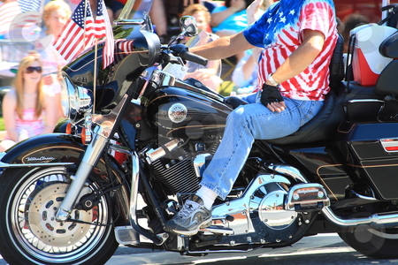 To use this stock image in your creative project, please select the size you need over to the right and click the "Add to Cart" button.
Your downloaded image will come with the Cutcaster watermark removed so don’t worry about the watermark you see on this page. Fourth of july stock photo, Motorcycle in parade by Jack Schiffer