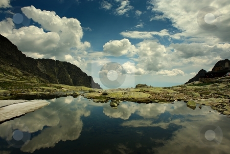 To use this stock image in your creative project, please select the size you need over to the right and click the "Add to Cart" button.
Your downloaded image will come with the Cutcaster watermark removed so don’t worry about the watermark you see on this page. Mountain lake with gorgeous sky stock photo, Mountain lake with gorgeous cloudy sky and a cottage by Juraj Kovacik
