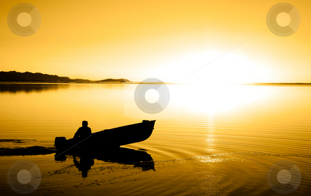 To use this stock image in your creative project, please select the size you need over to the right and click the "Add to Cart" button.
Your downloaded image will come with the Cutcaster watermark removed so don’t worry about the watermark you see on this page. Pacific Northwest Sunset stock photo, A man in a boat at Cline Spit in Sequim Washington. by Travis Manley
