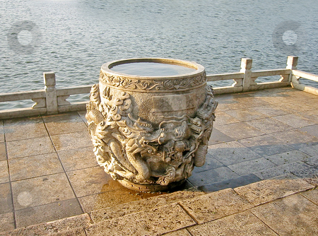 To use this stock image in your creative project, please select the size you need over to the right and click the "Add to Cart" button.
Your downloaded image will come with the Cutcaster watermark removed so don’t worry about the watermark you see on this page. Dragon wishing well stock photo, Stone wishing well filled with rain water by lake by Shi Liu