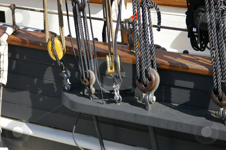 To use this stock image in your creative project, please select the size you need over to the right and click the "Add to Cart" button.
Your downloaded image will come with the Cutcaster watermark removed so don’t worry about the watermark you see on this page. Blocks and Rigging stock photo, A view of blocks and rigging on a tall ship / sailing ship. by Tom Weatherhead