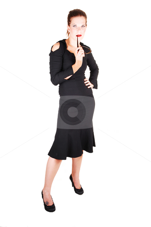 To use this stock image in your creative project, please select the size you need over to the right and click the "Add to Cart" button.
Your downloaded image will come with the Cutcaster watermark removed so don’t worry about the watermark you see on this page. Pretty girl in black dress. stock photo, Young lovely girl in a black dress and sunglasses in her mouth with bright red
lips standing in the studio for white background. by Horst Petzold