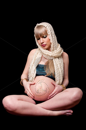 To use this stock image in your creative project, please select the size you need over to the right and click the "Add to Cart" button.
Your downloaded image will come with the Cutcaster watermark removed so don’t worry about the watermark you see on this page. Pregnant woman holding belly stock photo, Beatiful pregnant Caucasian woman with head scarf sitting in lotus position holding naked belly covered with rhinestones, isolated by Paul Hakimata