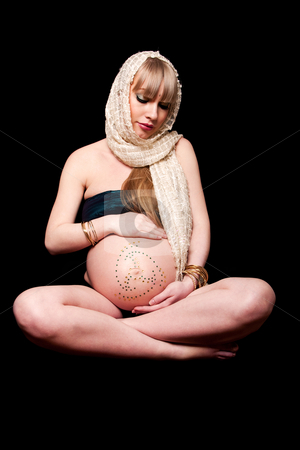 To use this stock image in your creative project, please select the size you need over to the right and click the "Add to Cart" button.
Your downloaded image will come with the Cutcaster watermark removed so don’t worry about the watermark you see on this page. Pregnant woman holding belly stock photo, Beautiful pregnant Caucasian woman with head scarf sitting in lotus position holding naked belly covered with rhinestones, isolated by Paul Hakimata