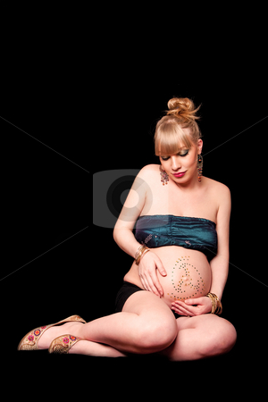 To use this stock image in your creative project, please select the size you need over to the right and click the "Add to Cart" button.
Your downloaded image will come with the Cutcaster watermark removed so don’t worry about the watermark you see on this page. Beautiful pregnant blond girl stock photo, Beautiful pregnant blond girl holding her bare belly covered in rhinestones while looking down and sitting, isolated by Paul Hakimata