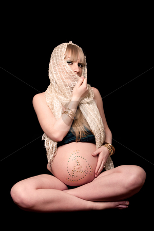 To use this stock image in your creative project, please select the size you need over to the right and click the "Add to Cart" button.
Your downloaded image will come with the Cutcaster watermark removed so don’t worry about the watermark you see on this page. Pregnant woman with veil stock photo, Beautiful pregnant woman with head scarf sitting in lotus position with hand on bare belly covered with rhinestones, isolated by Paul Hakimata