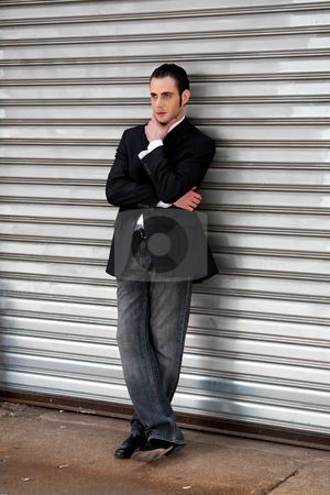 To use this stock image in your creative project, please select the size you need over to the right and click the "Add to Cart" button.
Your downloaded image will come with the Cutcaster watermark removed so don’t worry about the watermark you see on this page. Business man standing stock photo, Handsome casual business man standing in front of and leaning against silver metal garage door with hand on chin thinking by Paul Hakimata