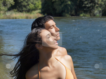 To use this stock image in your creative project, please select the size you need over to the right and click the "Add to Cart" button.
Your downloaded image will come with the Cutcaster watermark removed so don’t worry about the watermark you see on this page. Young couple at river looking up eyes closed stock photo, Mixed young couple outdoors at river looking up eyes closed by Jeff Cleveland