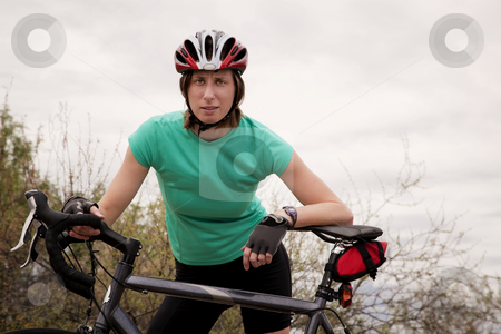 To use this stock image in your creative project, please select the size you need over to the right and click the "Add to Cart" button.
Your downloaded image will come with the Cutcaster watermark removed so don’t worry about the watermark you see on this page. Woman with Bicycle stock photo, Young woman wearing helmet leaning on a bicycle by Scott Griessel