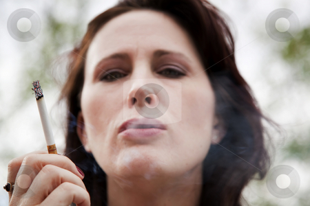 To use this stock image in your creative project, please select the size you need over to the right and click the "Add to Cart" button.
Your downloaded image will come with the Cutcaster watermark removed so don’t worry about the watermark you see on this page. Smoking Woman stock photo, Close-up of smoking young woman by Scott Griessel