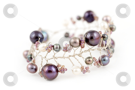 To use this stock image in your creative project, please select the size you need over to the right and click the "Add to Cart" button.
Your downloaded image will come with the Cutcaster watermark removed so don’t worry about the watermark you see on this page. Andaman sea pearl bracelet stock photo, A bracelet made of silver and blue and purple Andaman sea pearls on a white on a background by Stefan Breton