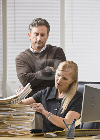 To use this stock image in your creative project, please select the size you need over to the right and click the "Add to Cart" button.
Your downloaded image will come with the Cutcaster watermark removed so don’t worry about the watermark you see on this page. Man Looking Over Woman's Shoulder stock photo, A businessman is standing in an office and looking over a woman's shoulder at the files on her desk. She is looking away from the camera. by Jonathan Ross