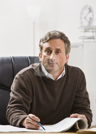 To use this stock image in your creative project, please select the size you need over to the right and click the "Add to Cart" button.
Your downloaded image will come with the Cutcaster watermark removed so don’t worry about the watermark you see on this page. Attractive male looking at camera. stock photo, Attractive male sitting at desk with pen and paper, looking at camera. Vertical by Jonathan Ross