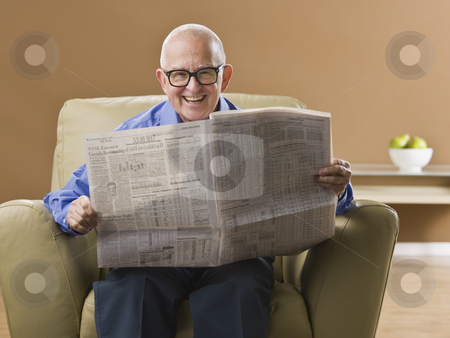 To use this stock image in your creative project, please select the size you need over to the right and click the "Add to Cart" button.
Your downloaded image will come with the Cutcaster watermark removed so don’t worry about the watermark you see on this page. Elderly Man Reading Newspaper stock photo, An elderly man is sitting in his living room reading a newspaper. He is smiling at the camera. Horizontally framed shot. by Jonathan Ross