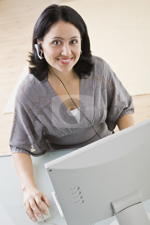 To use this stock image in your creative project, please select the size you need over to the right and click the "Add to Cart" button.
Your downloaded image will come with the Cutcaster watermark removed so don’t worry about the watermark you see on this page. Woman on Computer stock photo, A young businesswoman is seated in front of a computer and is smiling at the camera. Vertically framed shot. by Jonathan Ross