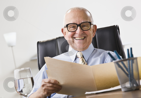 To use this stock image in your creative project, please select the size you need over to the right and click the "Add to Cart" button.
Your downloaded image will come with the Cutcaster watermark removed so don’t worry about the watermark you see on this page. Elderly Business Man Smiling stock photo, An elderly business man seated in an office and smiling. He is holding a file folder and is wearing glasses. Horizontally framed shot. by Jonathan Ross
