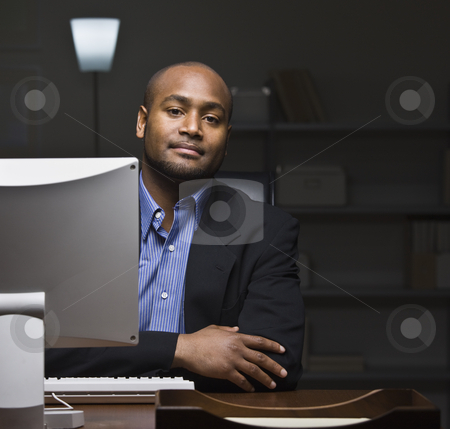 To use this stock image in your creative project, please select the size you need over to the right and click the "Add to Cart" button.
Your downloaded image will come with the Cutcaster watermark removed so don’t worry about the watermark you see on this page. Man at Computer Desk stock photo, A young businessman is seated at a desk and is working on a computer. He is looking at the camera. Square framed shot. by Jonathan Ross