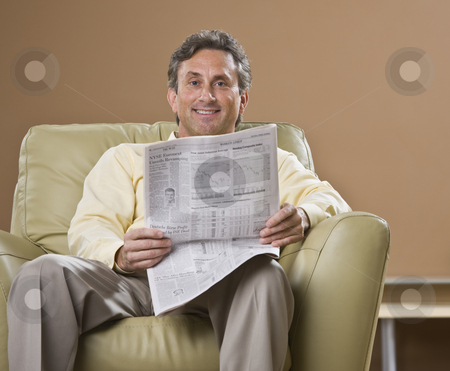 To use this stock image in your creative project, please select the size you need over to the right and click the "Add to Cart" button.
Your downloaded image will come with the Cutcaster watermark removed so don’t worry about the watermark you see on this page. Man Reading Newspaper stock photo, An older man is sitting in a chair and reading a newspaper. He is smiling at the camera. Horizontally framed shot. by Jonathan Ross