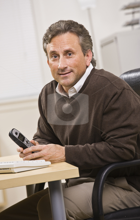 To use this stock image in your creative project, please select the size you need over to the right and click the "Add to Cart" button.
Your downloaded image will come with the Cutcaster watermark removed so don’t worry about the watermark you see on this page. Man Holding Telephone stock photo, A man is seated in an office holding a telephone. He is smiling at the camera. Vertically framed shot. by Jonathan Ross