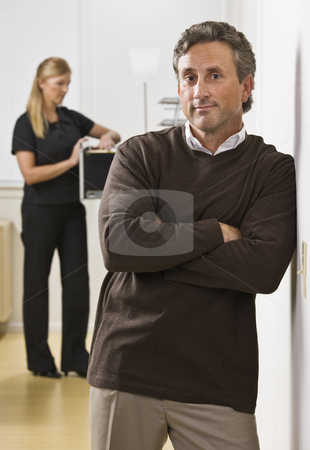 To use this stock image in your creative project, please select the size you need over to the right and click the "Add to Cart" button.
Your downloaded image will come with the Cutcaster watermark removed so don’t worry about the watermark you see on this page. Man and Woman in Office stock photo, A businessman and woman are standing in an office. The woman is looking in a filing cabinet and the man is looking at the camera. Vertically framed shot. by Jonathan Ross