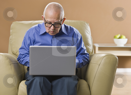 To use this stock image in your creative project, please select the size you need over to the right and click the "Add to Cart" button.
Your downloaded image will come with the Cutcaster watermark removed so don’t worry about the watermark you see on this page. Man on Laptop stock photo, An elderly man is working on a laptop and looking away from the camera. Horizontally framed shot. by Jonathan Ross