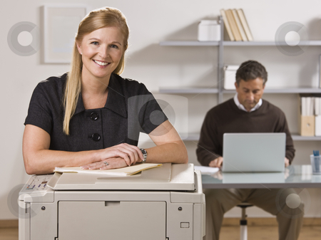 To use this stock image in your creative project, please select the size you need over to the right and click the "Add to Cart" button.
Your downloaded image will come with the Cutcaster watermark removed so don’t worry about the watermark you see on this page. Man and Woman Working in Office stock photo, A businessman and woman are working in an office. The man is working on a laptop and the woman is smiling at the camera. Horizontally framed shot. by Jonathan Ross