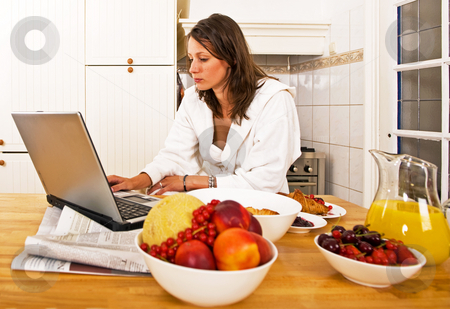 To use this stock image in your creative project, please select the size you need over to the right and click the "Add to Cart" button.
Your downloaded image will come with the Cutcaster watermark removed so don’t worry about the watermark you see on this page. Sunday brunch stock photo, Young woman, catching up with the day's events on her laptop whilst drinking a glass of orange jus by Corepics VOF