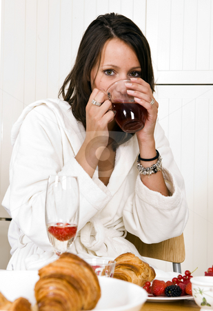 To use this stock image in your creative project, please select the size you need over to the right and click the "Add to Cart" button.
Your downloaded image will come with the Cutcaster watermark removed so don’t worry about the watermark you see on this page. Morning tea stock photo, Pretty young woman, dressed in a bathrobe, drinking a cup of tea with both hands on a luxurious sunday morning breakfast by Corepics VOF