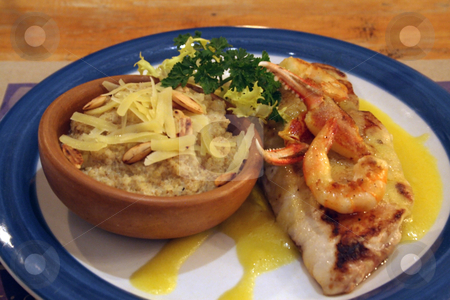 To use this stock image in your creative project, please select the size you need over to the right and click the "Add to Cart" button.
Your downloaded image will come with the Cutcaster watermark removed so don’t worry about the watermark you see on this page. Fish with Shrimp and Crab sauce with Quinoa risotto with almonds stock photo, Fish with Shrimp and Crab sauce with Quinoa risotto with almonds, dish served in Chile by Philip Muller