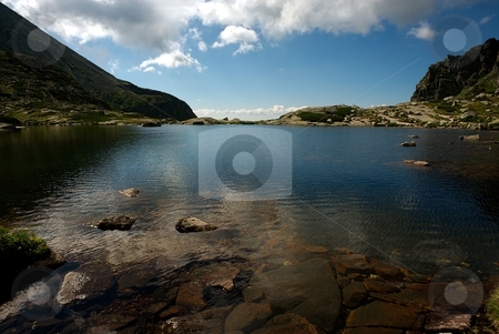 To use this stock image in your creative project, please select the size you need over to the right and click the "Add to Cart" button.
Your downloaded image will come with the Cutcaster watermark removed so don’t worry about the watermark you see on this page. Mountain lake horizon stock photo, Mountain lake with straight horizon and reflecting blue sky with some clouds by Juraj Kovacik