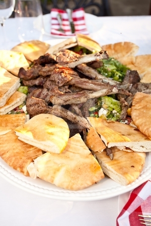 To use this stock image in your creative project, please select the size you need over to the right and click the "Add to Cart" button.
Your downloaded image will come with the Cutcaster watermark removed so don’t worry about the watermark you see on this page. Lamb Ribs stock photo, Grilled lamb ribs with pita bread and vegetables. by Mariusz Jurgielewicz
