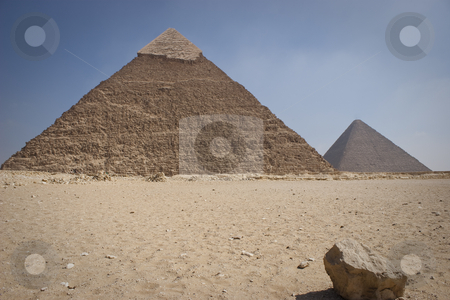 To use this stock image in your creative project, please select the size you need over to the right and click the "Add to Cart" button.
Your downloaded image will come with the Cutcaster watermark removed so don’t worry about the watermark you see on this page. The Pyramid of Khafrae stock photo, The Pyramid of Khafrae is the second largest of the Ancient Egyptian Pyramids of Giza and the tomb of the fourth-dynasty pharaoh Khafre (Chephren in Greek), The pyramid has a base length of 215.25 m (706 ft) and originally rises to a height of 143.5 m (471 ft). The Pyramid is made of Limestone blocks (weighing more than 2 tons each). The slope of the pyramid rises at an 53 by Amr Hassanein