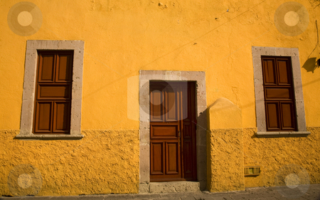 To use this stock image in your creative project, please select the size you need over to the right and click the "Add to Cart" button.
Your downloaded image will come with the Cutcaster watermark removed so don’t worry about the watermark you see on this page. Yellow Adobe House Brown Doors Morelia Mexico stock photo, Bright Yellow Adobe House with brown doors Morelia Mexico by William Perry