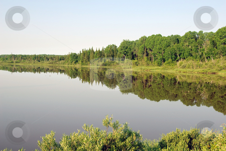 To use this stock image in your creative project, please select the size you need over to the right and click the "Add to Cart" button.
Your downloaded image will come with the Cutcaster watermark removed so don’t worry about the watermark you see on this page. Lake in summer stock photo, A very calm lake on a sunny summer day by Alain Turgeon