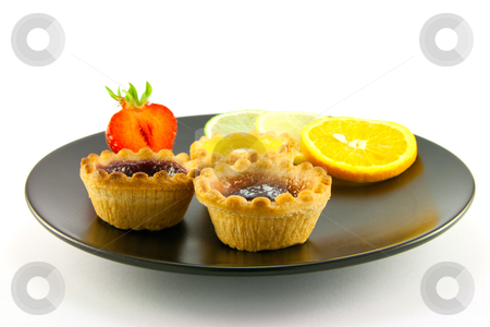 To use this stock image in your creative project, please select the size you need over to the right and click the "Add to Cart" button.
Your downloaded image will come with the Cutcaster watermark removed so don’t worry about the watermark you see on this page. Jam Tarts on a Black Plate stock photo, Red and yellow small jam tarts with slices of lemon, lime, orange and strawberry on a black plate on a white background by Keith Wilson