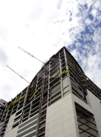 To use this stock image in your creative project, please select the size you need over to the right and click the "Add to Cart" button.
Your downloaded image will come with the Cutcaster watermark removed so don’t worry about the watermark you see on this page. Building Under Construction stock photo, A large building that is under construction by Kevin Tietz