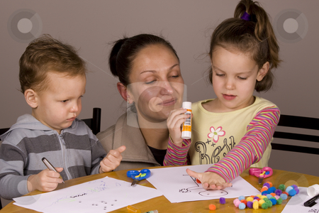 To use this stock image in your creative project, please select the size you need over to the right and click the "Add to Cart" button.
Your downloaded image will come with the Cutcaster watermark removed so don’t worry about the watermark you see on this page. Family fun stock photo, Mother and kids spending time together doing arts and craft by Jandrie Lombard