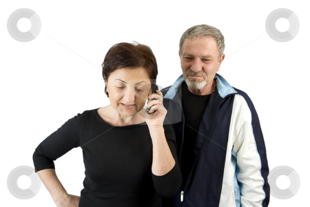 To use this stock image in your creative project, please select the size you need over to the right and click the "Add to Cart" button.
Your downloaded image will come with the Cutcaster watermark removed so don’t worry about the watermark you see on this page. Wife on the Phone while Husband Waiting for the News stock photo, Wife on the Phone while Husband Waiting for the News - Isolated by Mehmet Dilsiz
