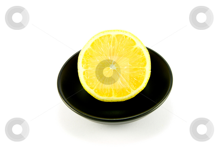 To use this stock image in your creative project, please select the size you need over to the right and click the "Add to Cart" button.
Your downloaded image will come with the Cutcaster watermark removed so don’t worry about the watermark you see on this page. Half a Lemon stock photo, Half a juicy yellow lemon in a small black dish on a white background by Keith Wilson
