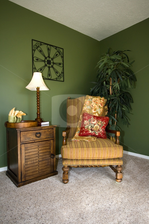 To use this stock image in your creative project, please select the size you need over to the right and click the "Add to Cart" button.
Your downloaded image will come with the Cutcaster watermark removed so don’t worry about the watermark you see on this page. Family Room with Reading Chair and night stand stock photo, Close up on a corner of a house with a chair and nightstand by Mehmet Dilsiz