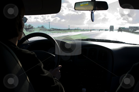 To use this stock image in your creative project, please select the size you need over to the right and click the "Add to Cart" button.
Your downloaded image will come with the Cutcaster watermark removed so don’t worry about the watermark you see on this page. On the Stormy Road Driving stock photo, Woman driving on the stormy road with headsets listening to music by Mehmet Dilsiz