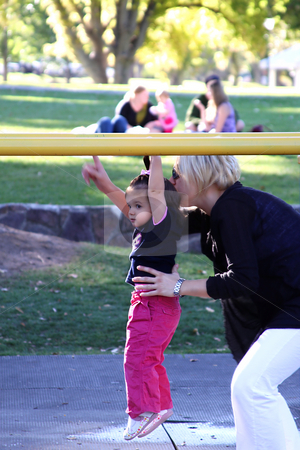 To use this stock image in your creative project, please select the size you need over to the right and click the "Add to Cart" button.
Your downloaded image will come with the Cutcaster watermark removed so don’t worry about the watermark you see on this page. Mother and Daugher Playing in the Park stock photo, Mother helping her daughter on the monkey bars by Mehmet Dilsiz