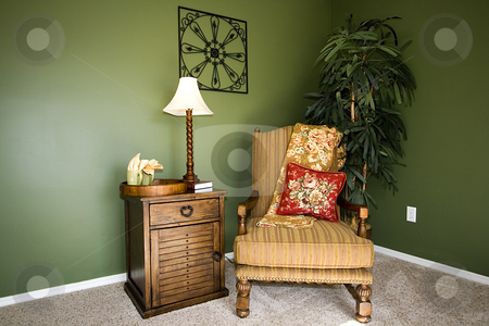 To use this stock image in your creative project, please select the size you need over to the right and click the "Add to Cart" button.
Your downloaded image will come with the Cutcaster watermark removed so don’t worry about the watermark you see on this page. Family Room with Reading Chair and night stand stock photo, Close up on a corner of a house with a chair and nightstand by Mehmet Dilsiz