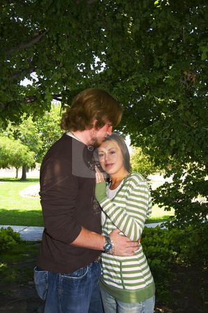 To use this stock image in your creative project, please select the size you need over to the right and click the "Add to Cart" button.
Your downloaded image will come with the Cutcaster watermark removed so don’t worry about the watermark you see on this page. Young couple hugging under the trees in a park stock photo, Young Married hugging under the trees in a park by Mehmet Dilsiz