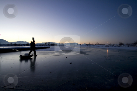To use this stock image in your creative project, please select the size you need over to the right and click the "Add to Cart" button.
Your downloaded image will come with the Cutcaster watermark removed so don’t worry about the watermark you see on this page. Fisherman Walking on Ice to Catch Fish stock photo, Early in the Morning a Fisherman Walking on Ice to Catch Fish by Mehmet Dilsiz